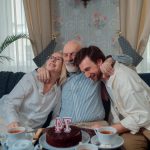 A joyful family celebration with cake and tea, capturing warmth and togetherness indoors.