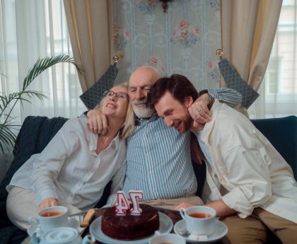 A joyful family celebration with cake and tea, capturing warmth and togetherness indoors.