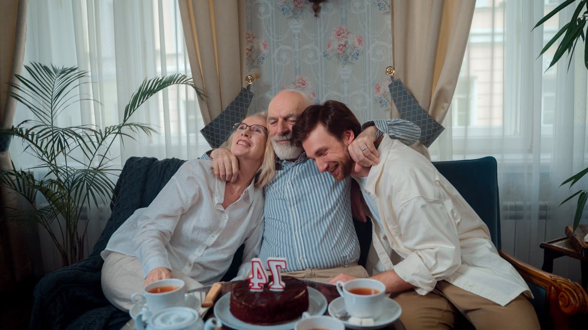 A joyful family celebration with cake and tea, capturing warmth and togetherness indoors.